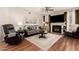 Inviting living room featuring a fireplace, stylish furnishings, and a ceiling fan at 14250 W Wigwam Blvd # 812, Litchfield Park, AZ 85340