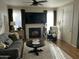 Bright living room with gray sofa, fireplace, and large TV for entertainment at 14250 W Wigwam Blvd # 812, Litchfield Park, AZ 85340