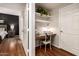 Office nook with a built-in desk, shelves, and contemporary decor adjacent to the bedroom at 14250 W Wigwam Blvd # 812, Litchfield Park, AZ 85340