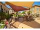Inviting outdoor kitchen with a built-in grill, bar seating, and shaded dining area at 14250 W Wigwam Blvd # 812, Litchfield Park, AZ 85340