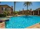 Stunning community swimming pool surrounded by lush landscaping and comfortable lounge chairs at 14250 W Wigwam Blvd # 812, Litchfield Park, AZ 85340