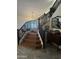 Elegant staircase with dark wood railing and herringbone floors, leading to a spacious dining area at 16050 N 35Th Dr, Phoenix, AZ 85053