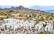Aerial view showcasing modern condos nestled amidst a lush, green landscape with mountains in the backdrop at 1717 E Morten Ave # 7, Phoenix, AZ 85020