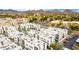 Aerial view of a condo community with a pool, parking, and stunning mountain views in the distance at 1717 E Morten Ave # 7, Phoenix, AZ 85020
