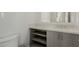 Modern bathroom with quartz countertop, vanity cabinet with shelving, and sleek faucet at 1717 E Morten Ave # 7, Phoenix, AZ 85020