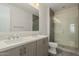 Bright bathroom featuring dual sinks, large mirror, and glass walk-in shower at 1717 E Morten Ave # 7, Phoenix, AZ 85020