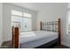 Bedroom with unique wooden headboard, bright white walls, and natural light from the windows at 1717 E Morten Ave # 7, Phoenix, AZ 85020
