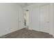 Bedroom featuring neutral carpet, closet with sliding doors, and bright white walls at 1717 E Morten Ave # 7, Phoenix, AZ 85020