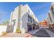 View of a three-story white home with black accents, featuring a private garage and modern design at 1717 E Morten Ave # 7, Phoenix, AZ 85020