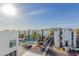 View of modern condo buildings with a community pool, palm trees, and well-manicured landscaping under a sunny sky at 1717 E Morten Ave # 7, Phoenix, AZ 85020