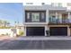 Contemporary three-story home with a black garage door and landscaped front yard at 1717 E Morten Ave # 7, Phoenix, AZ 85020