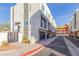 View of a three-story white home with black accents, featuring a private garage and modern design at 1717 E Morten Ave # 7, Phoenix, AZ 85020