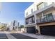 View of modern townhomes with black garage doors and manicured landscaping at 1717 E Morten Ave # 7, Phoenix, AZ 85020