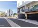 View of modern townhomes with black garage doors and manicured landscaping at 1717 E Morten Ave # 7, Phoenix, AZ 85020