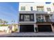 Contemporary three-story home with a black garage door and landscaped front yard at 1717 E Morten Ave # 7, Phoenix, AZ 85020