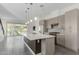 Modern kitchen with a large island, stainless steel appliances, and gray cabinets at 1717 E Morten Ave # 7, Phoenix, AZ 85020