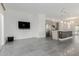 Open living room with tile floors, a large window, and a modern kitchen in the background at 1717 E Morten Ave # 7, Phoenix, AZ 85020