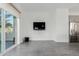 Spacious living room with modern tile flooring, large window and flat-screen TV at 1717 E Morten Ave # 7, Phoenix, AZ 85020