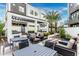 Outdoor seating area with grills, a fire pit, and desert landscaping surrounded by modern condo buildings at 1717 E Morten Ave # 7, Phoenix, AZ 85020