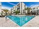 Community pool area with modern buildings, a blue pool with black tile, and desert landscaping at 1717 E Morten Ave # 7, Phoenix, AZ 85020