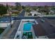 Aerial view of a backyard featuring a sparkling pool, lounge area, and cozy seating under string lights at 1744 E Luke Ave, Phoenix, AZ 85016
