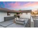 Inviting backyard patio with modern outdoor furniture, set on a paved area with a stylish concrete design at 1744 E Luke Ave, Phoenix, AZ 85016