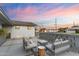Backyard patio featuring comfortable outdoor seating, complemented by stylish pavers and low-maintenance landscaping at 1744 E Luke Ave, Phoenix, AZ 85016