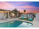 Inviting backyard with a pool, covered patio, lounge area, and outdoor dining space at 1744 E Luke Ave, Phoenix, AZ 85016