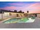 Backyard view of a pool, covered patio with dining, and lounge area, great for outdoor living at 1744 E Luke Ave, Phoenix, AZ 85016