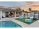 Inviting backyard features a pool, outdoor kitchen, covered patio, and lounge area, perfect for relaxing at 1744 E Luke Ave, Phoenix, AZ 85016