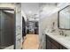 This bathroom features marble tiling, dark cabinets, and an entrance to the walk-in closet at 1744 E Luke Ave, Phoenix, AZ 85016