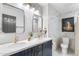 Modern bathroom features double sinks with marble countertops, contemporary fixtures, and stylish tile work at 1744 E Luke Ave, Phoenix, AZ 85016