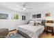 Well-lit bedroom featuring a queen bed, neutral decor, and dual windows for natural light at 1744 E Luke Ave, Phoenix, AZ 85016