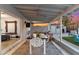 Covered patio boasts an outdoor dining area with a view of the backyard at 1744 E Luke Ave, Phoenix, AZ 85016