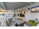 Relaxing covered patio with dining area, lounge, and sliding glass doors to the home's interior at 1744 E Luke Ave, Phoenix, AZ 85016