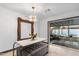 Elegant dining room featuring a large mirror, stylish chandelier, and sliding glass doors to the outdoor patio at 1744 E Luke Ave, Phoenix, AZ 85016