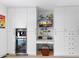 Well-lit home office area with sleek white cabinets, built-in desk, and modern appliances for convenient working space at 1744 E Luke Ave, Phoenix, AZ 85016