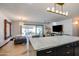 Open floorplan showing island in kitchen looking into living room and backyard at 1744 E Luke Ave, Phoenix, AZ 85016