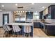 Bright, modern kitchen with marble countertops, an island with seating, and updated fixtures at 1744 E Luke Ave, Phoenix, AZ 85016