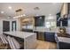 Contemporary kitchen with waterfall island, stainless steel appliances, and dark cabinetry at 1744 E Luke Ave, Phoenix, AZ 85016