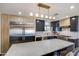 Close up of modern kitchen island with marble countertop, stainless steel appliances, and custom cabinetry at 1744 E Luke Ave, Phoenix, AZ 85016