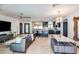 Open-concept living space boasts a stylish kitchen island, modern lighting, and comfortable seating at 1744 E Luke Ave, Phoenix, AZ 85016
