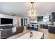 Open concept kitchen and living room featuring modern lighting fixtures and updated features at 1744 E Luke Ave, Phoenix, AZ 85016