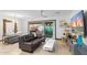 Bright living room featuring hardwood floors, a modern ceiling fan, and sliding glass doors to the backyard at 1744 E Luke Ave, Phoenix, AZ 85016