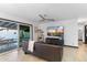 Cozy living room featuring a comfortable couch, hardwood floors, and a sliding glass door leading to the backyard at 1744 E Luke Ave, Phoenix, AZ 85016