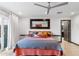Large main bedroom boasts a queen bed, wood floors, and ensuite bath at 1744 E Luke Ave, Phoenix, AZ 85016