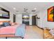 Spacious main bedroom with a queen-size bed, wood floors, and a wet bar at 1744 E Luke Ave, Phoenix, AZ 85016