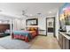 Spacious main bedroom with a queen-size bed, wood floors, and ensuite bath at 1744 E Luke Ave, Phoenix, AZ 85016