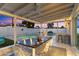 Covered patio with dining area and bar next to the pool; a great space for entertaining or relaxation at 1744 E Luke Ave, Phoenix, AZ 85016