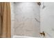 The shower features elegant marble-look tiles with gold fixtures and shower curtain at 1744 E Luke Ave, Phoenix, AZ 85016